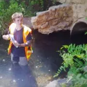 Justin Zweifel standing in knee-deep water